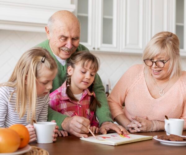 medium-shot-grandparents-girls-indoors-scaled-600x500 (1)