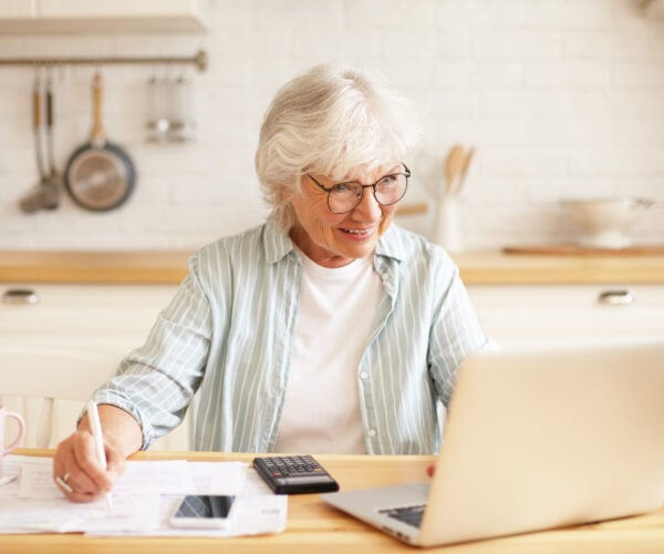 Woman in a kitchen on a computer
